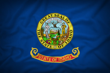 Idaho flag on the fabric texture background,Vintage style
