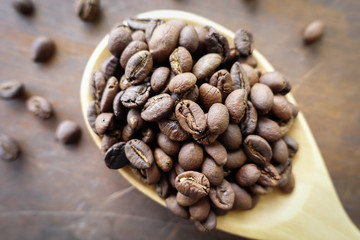 Coffee beans on wooden spoon