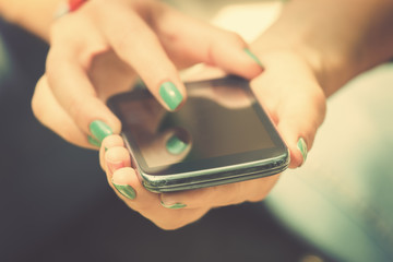 Texting on a smartphone. Shallow depth of field.