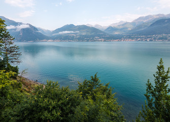 Como lake landscape with clouds. Water and mountains in Italy, Alps, Europe.