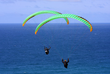 Paragliders above the sea