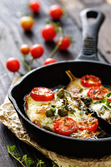 Baked eggplant stuffed with vegetables and mozzarella cheese with addition aromatic herbs. Delicious vegetarian dish