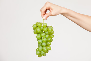 Female hand holding a  bunch of grapes