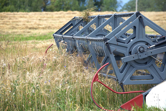 Grain harvester agricultural rotary combine in a field on summer day. Photo closeup
