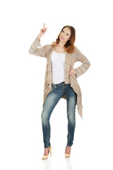 Happy smiling woman pointing up.