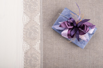 Gift box on linen tablecloth