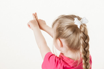 Caucasian little girl turning back and indicating something up