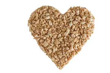 Heart shape made of textured soy protein granules viewed from above, isolated on white background.