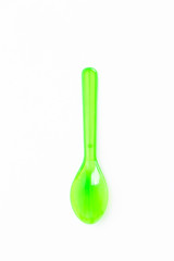 Green plastic spoon on white background