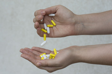 woman pouring a pills from one hand to another