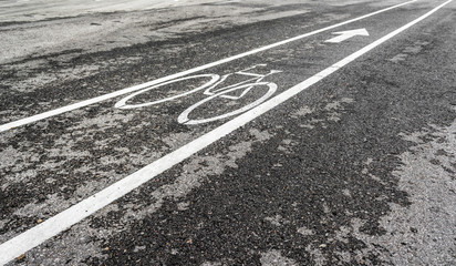asphalt road and bike lane with sign