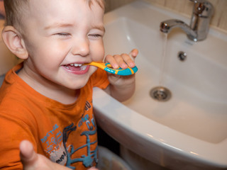 Cute toddler boy brushing teeth. cleaning, dental care.