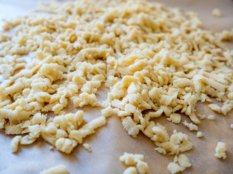 prepared grated row dough on wooden table