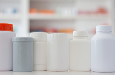 many medicine bottle with blur shelves of drug in the pharmacy d