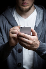 The man with the phone in his hand. Photography in low key