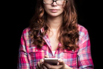 Fototapeta premium The girl with the phone. Photography in low key