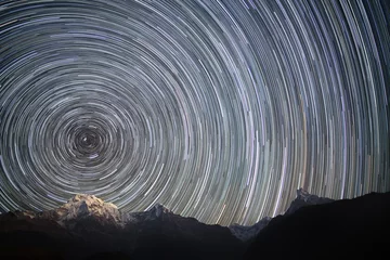 Foto auf Acrylglas Spinning Universe.  Star trails over the snowy mountains.  © Jankovoy