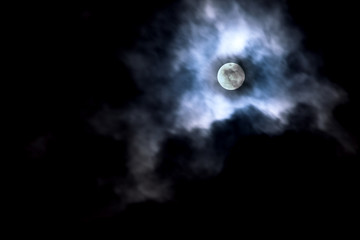Naklejka na ściany i meble Moon in cloud movement.