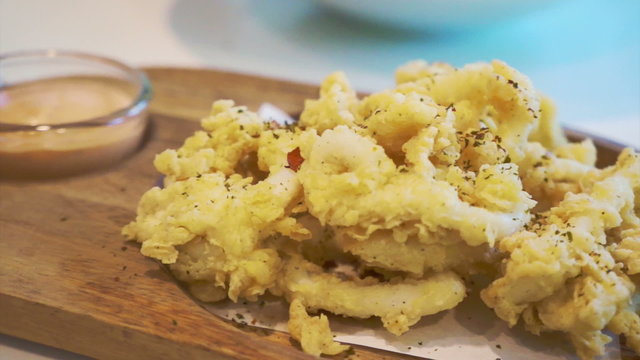 fries calamari on wood platter appetiser