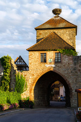 Medieval castle tower with gates and stork nest on the top