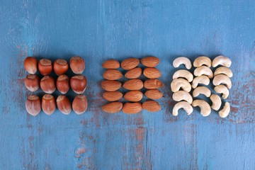 Dried fruits and nuts on color wooden background