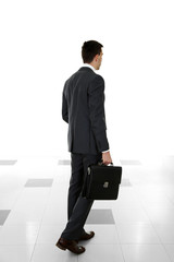 Man holding suitcase on light background