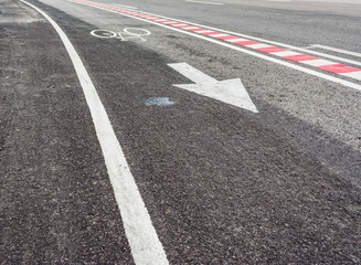 asphalt road and bike lane with sign