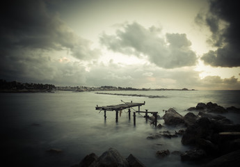 Dramatic sunset on the Mediterranean Sea, the pier was destroyed
