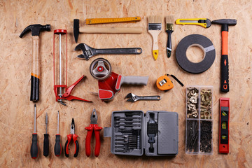 Set of tools on plywood, top view