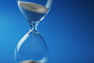 Hourglass on blue background