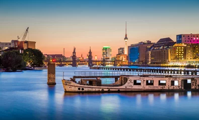 Fototapeten Berliner Skyline mit altem Schiffswrack in der Spree in der Abenddämmerung, Deutschland © JFL Photography