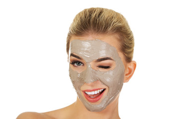 Young happy woman with facial mask.