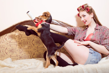 Sexi young smiling girl playing with a dog 