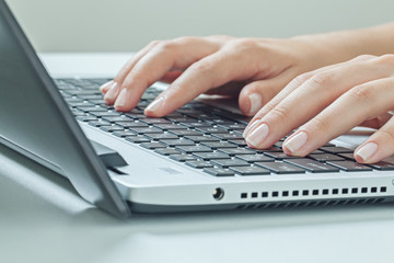 Macro photo of female hands typing on laptop. businesswoman work