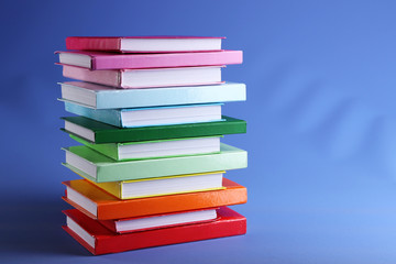 Colorful books on blue background