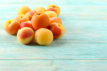 Ripe apricots on wooden table close up