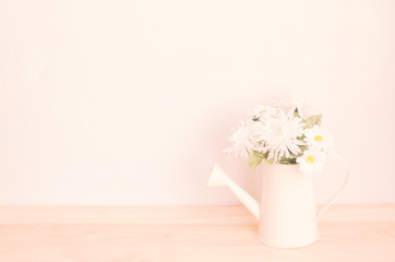 Artificial flower in old watering can with soft vintage color