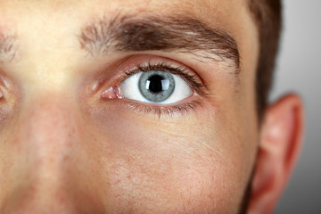 Beautiful blue man eye close up