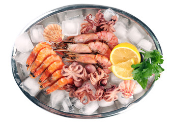 Seafood with lemon and ice on metal tray isolated on white