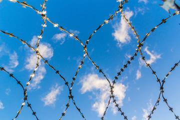 Barbed wire against the sky