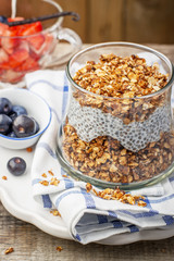 Strawberry, blueberries, oatmeal and chia seeds pudding in a jar for breakfast