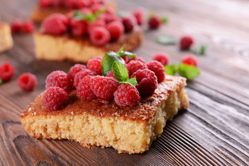 Fresh pie with raspberry on wooden table, closeup