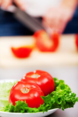 Young woman making salad