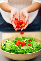Young woman making salad