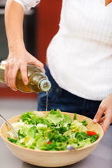 Young woman making salad