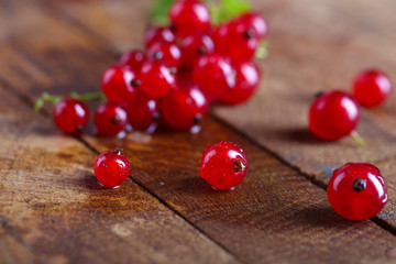 Fresh red currants on wooden table close up