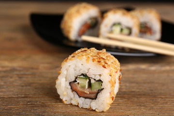Rolls with sticks on wooden table close up