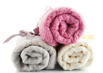 Obraz na płótnie Canvas Rolled up colorful towels isolated on white