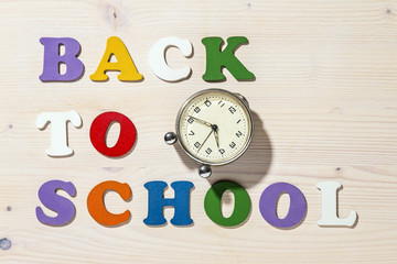 Wooden Colorful Letters Spelling Back To School With Old Clock