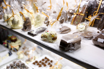 Showcase with chocolate candies close up